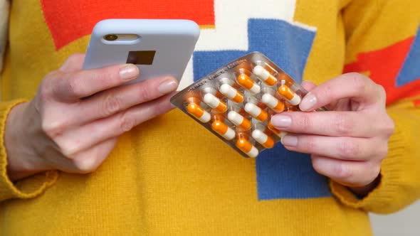 The Girl Uses Her Smartphone To Order Medicines in the Online Store By Scanning a Barcode or QR