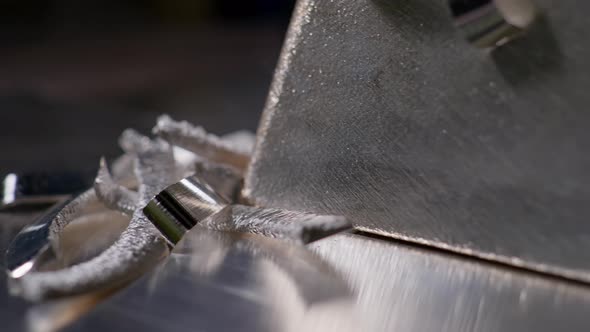 Close Up at the Surface of Processed and Polished Silver Bar and Metal Shavings Left After at the