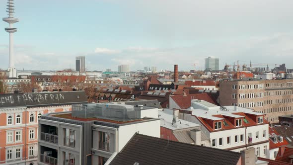 Low Aerial View of House Rooftops in Residential Neighborhood Near Radio Telecommunication Tower in