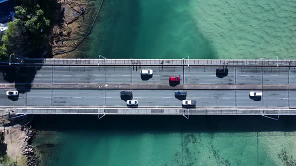 Coastal road and pedestrian bridge spanning a clear ocean estuary allowing people and vehicles to cr