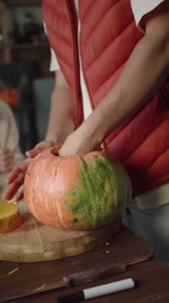 A Man is Professionally Carving the Pumpkin