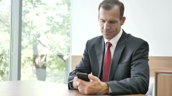 Businessman Typing Message on Smartphone Chatting