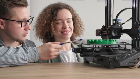 Modern Technologies Smart Man and Young Woman Create Technological Prototype Using 3D Print at Home