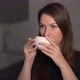 A Young Woman is Holding a Cup of Tea or Coffee for Breakfast - VideoHive Item for Sale