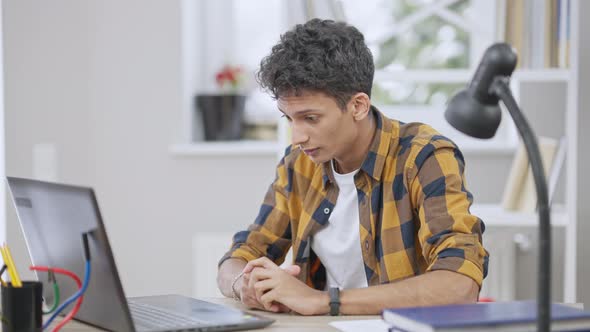 Slowmo of Excited Middle Eastern Young Man Pressing Keyboard on Laptop and Dollars Falling