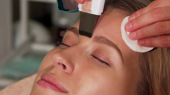 Young Woman Undergoing Ultrasonic Facial Treatment at Beauty Salon