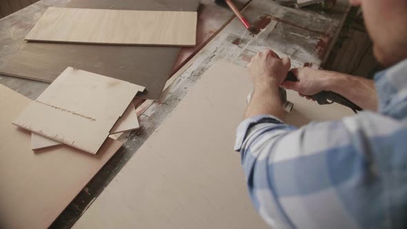 Carpenter Uses a Grinding Machine to Align