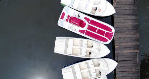 Aerial Shot Of Row Boats Piled In A Wooden Dock During Summer