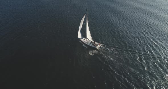 Top Down Slow Motion of Sailing Yacht, Aerial Sailboat Regatta Under Sails at Open Sea alt