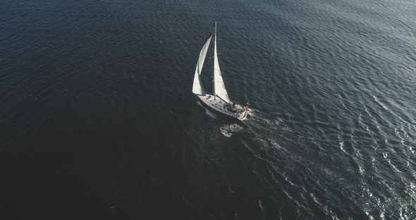 Top Down Slow Motion of Sailing Yacht, Aerial Sailboat Regatta Under Sails at Open Sea
