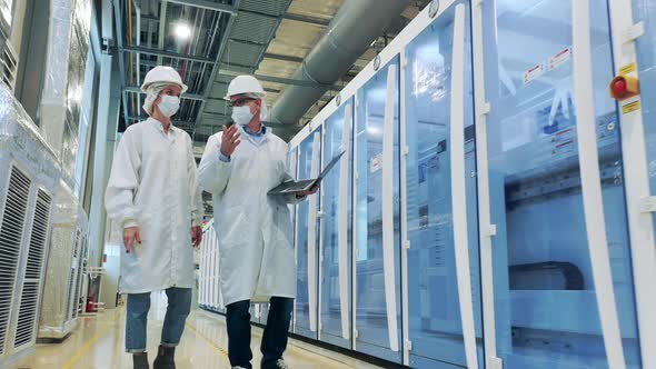 Male Specialist is Talking to His Colleague in the Factory Unit