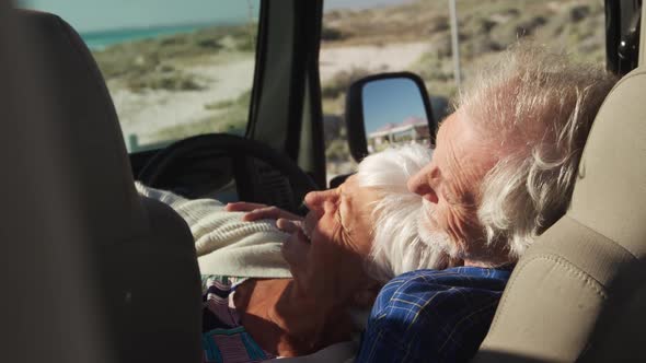 Senior couple leaning together in a car