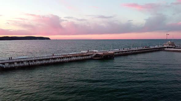 Cinematic pier in the sunset from a bird's eye view. Filming at sunset in Sopot.