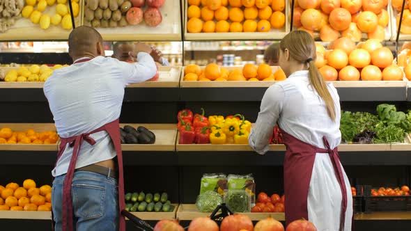 Small Business Owners Arranging Groceries at Store