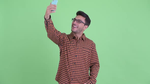 Happy Young Hispanic Hipster Man Taking Selfie