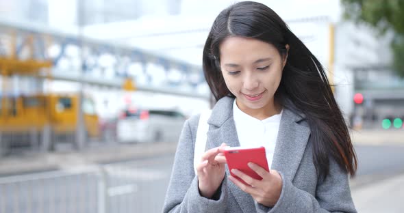 Business woman using smart phone in city