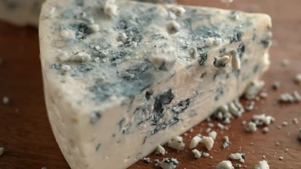 Gorgonzola cheese on wooden board. Slow Motion.