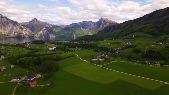 Beautiful view on the Mountains, lake and a Village Drone Video