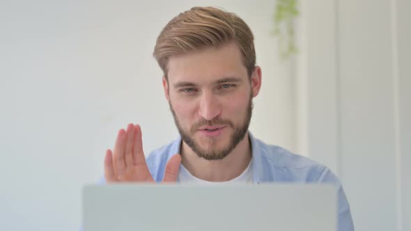 Portrait of Successful Creative Man Celebrating on Laptop at Work