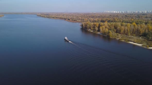 Aerial: The ship goes by Dnipro river in autumn