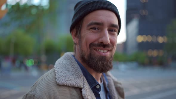 Pleased man wearing hat looking at the camera