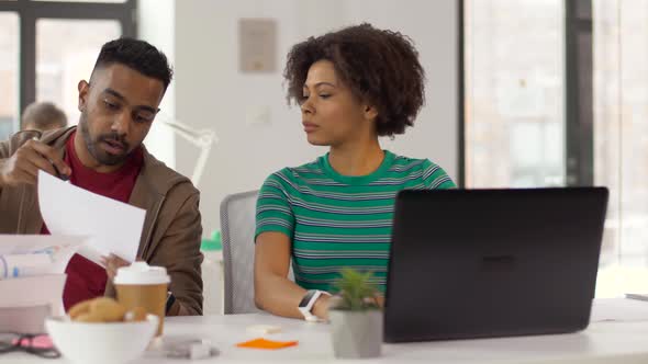 Creative Workers Discussing Papers at Office 12