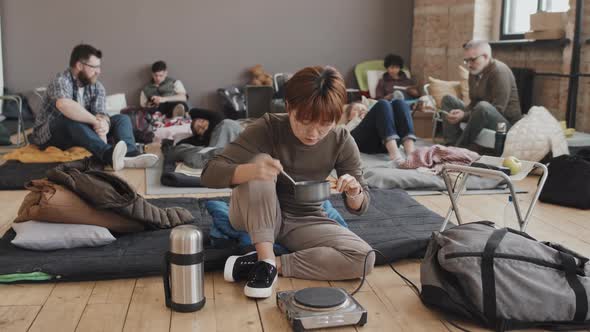 Woman Tasting Food in Refuge