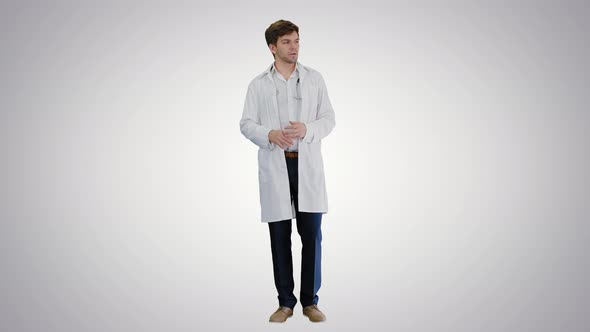 Male Doctor Talking To Camera Explaining Something on Gradient Background.