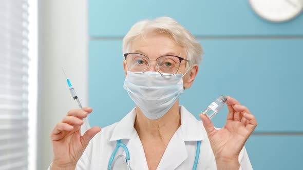 Mature female doctor with spectacles and medical mask