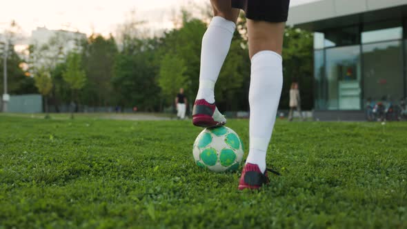 Woman Football Player Training Day on the Grass Field in the the Evening Park a Freestyler Leads the