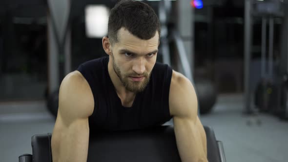 Handsome Bodybuilder Doing Weight Lifting in Gym Close Up