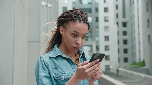 African American Woman Using Smart Phone Winning Concept Celebrating Success