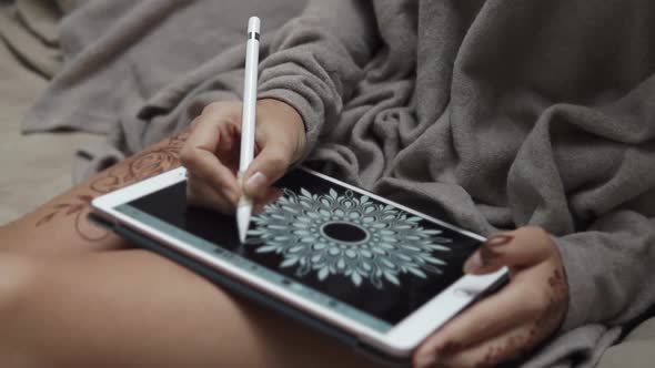 Close Up Shot of a Woman's Hands, Who Draws a Flower on a Portable Tablet