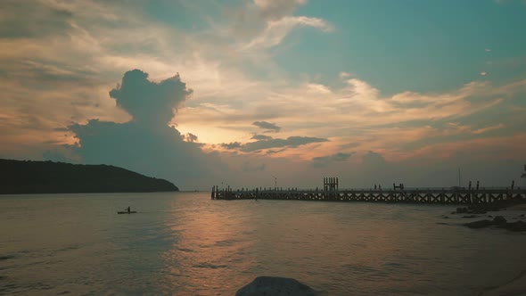 Bay and beach near the pier with small island view during sunset