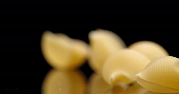 Dry Pasta Rigati Falls on the Table. 