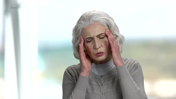Senior Woman Suffering From Migraine.