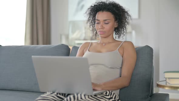 African Woman Working on Laptop at Home