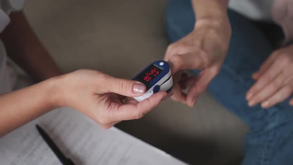 Medic and Patient Using Finger Pulse Oximeter