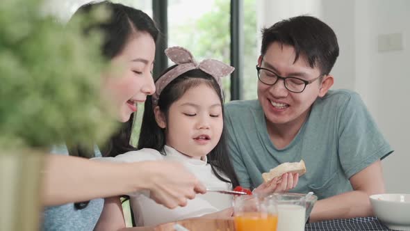 Happiness Asian Japanese family  breakfast at home. young parent and daughter