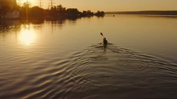 Man floating in boat on vacation. Swimming on kayak boat. Fitness workout with oars. Water tourism. 