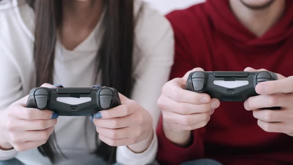 Video Games Controllers Are in the Couple's Hands