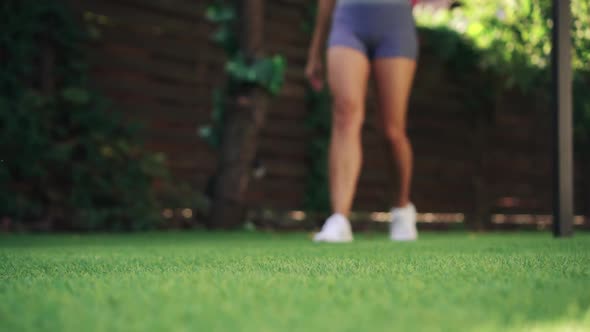 Close-up of Legs, Woman Comes on Green Lawn for Training