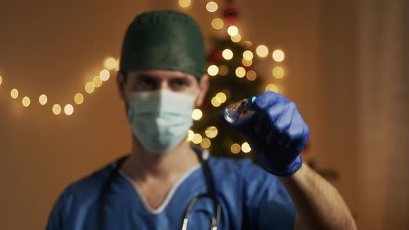 Doctor with vaccine on Christmas Background