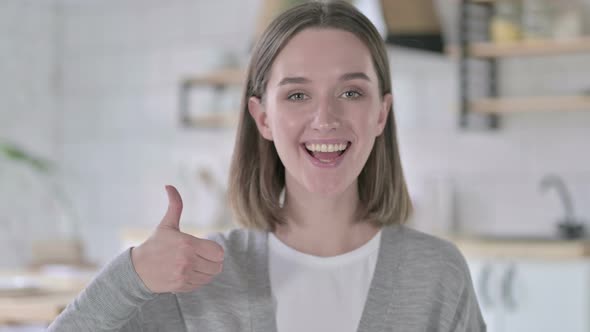 Portrait of Cheerful Young Woman Showing Thumbs Up