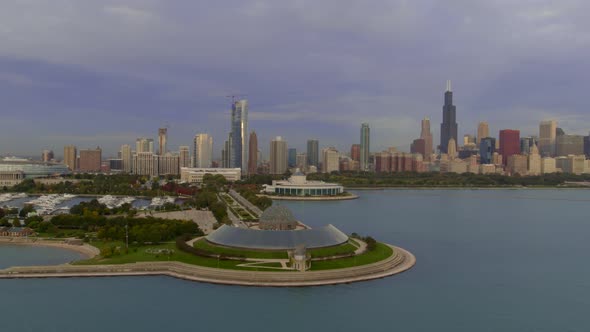Aerial of Adler planetarium in Lake Michigan and Chicago city in background