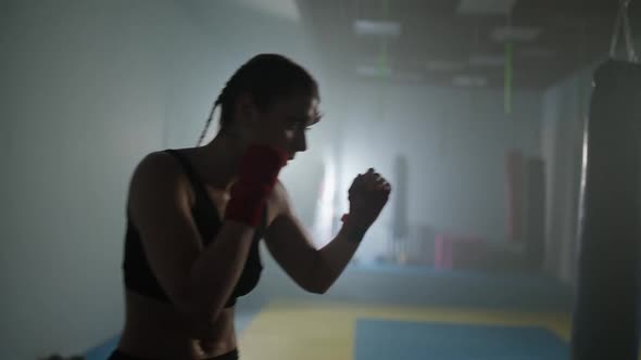 Female Fighter Trains His Punches and Defense in the Boxing Gym Contour Lighting Sports and Martial