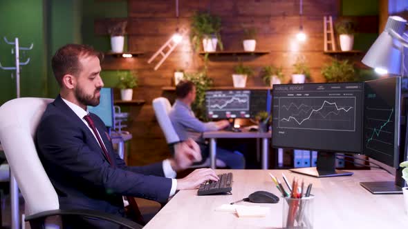 Businessman in Suit Working Late at Night Hours in the Office