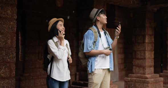 Couple takes a photo on smartphone and visits ancient temple