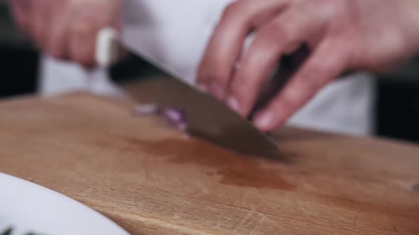 Close Up of Chef Cutting Red Onion on the Cutting Board Restaurant