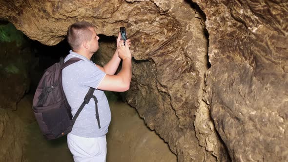 Tourist with a backpack in the cave. Speleology, cave, dungeon
